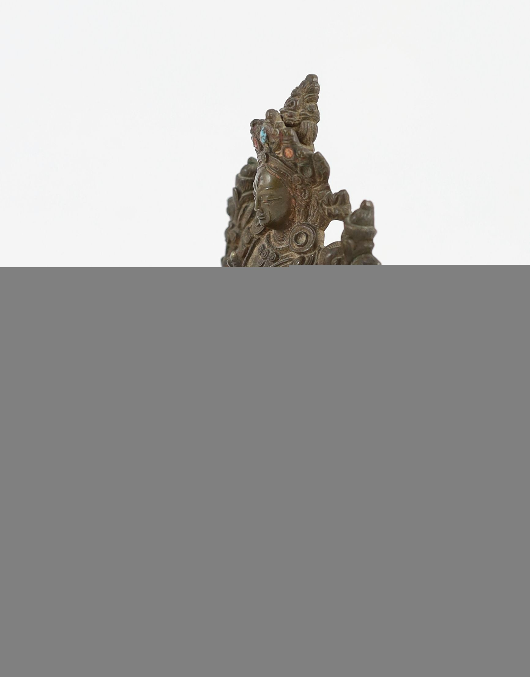 A Tibetan bronze seated figure of White Tara, 17th/18th century, 11 cm high